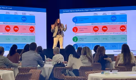 On stage presenting slides to an audience